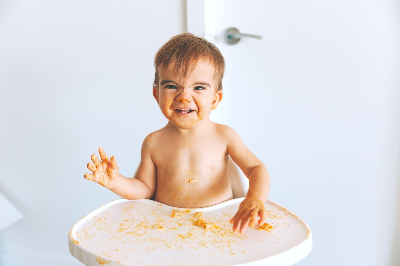 Baby throwing food from a high chair