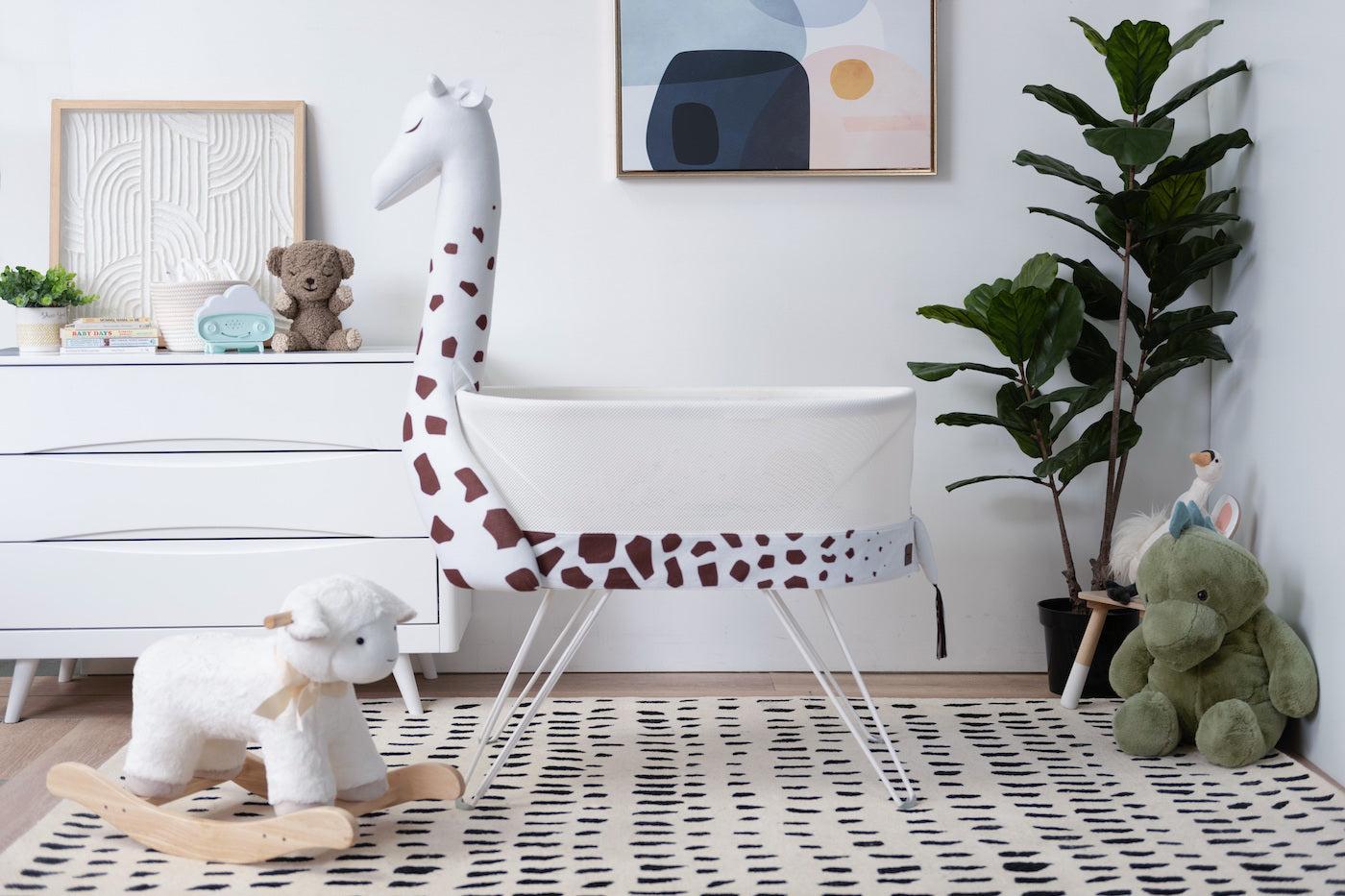 SNOO Zoo stuffed giraffe accessory in a safari-themed baby nursery