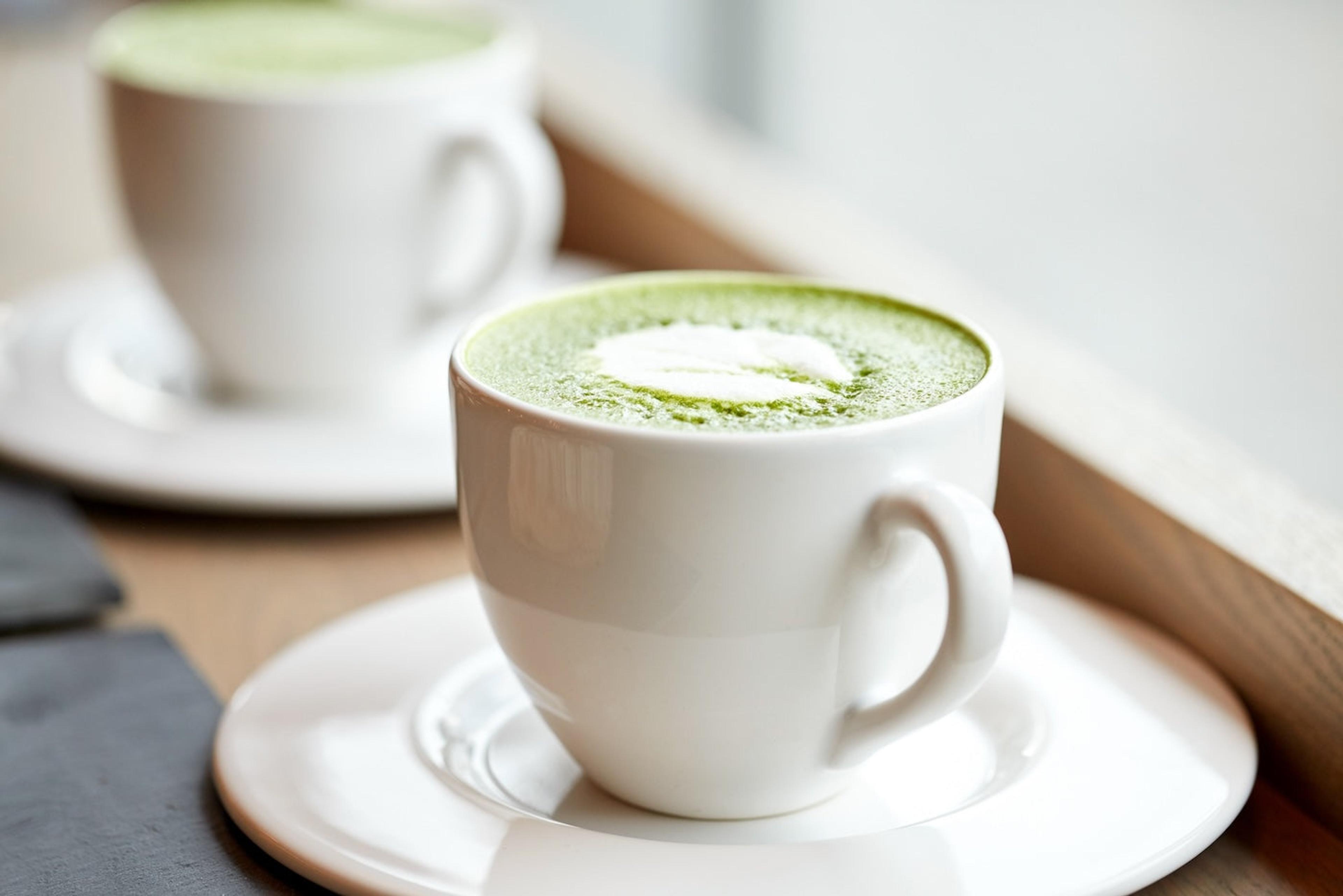 Two matcha lattes in mugs