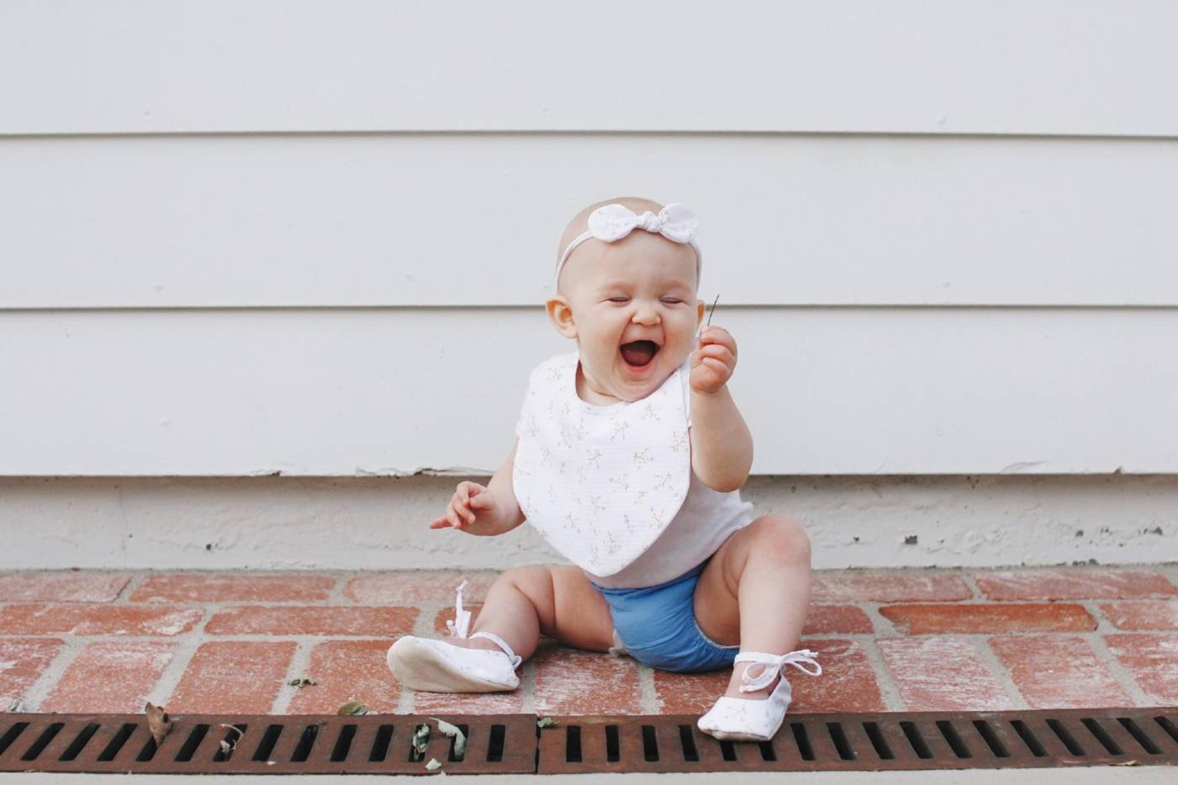 Happy baby girl sitting outside
