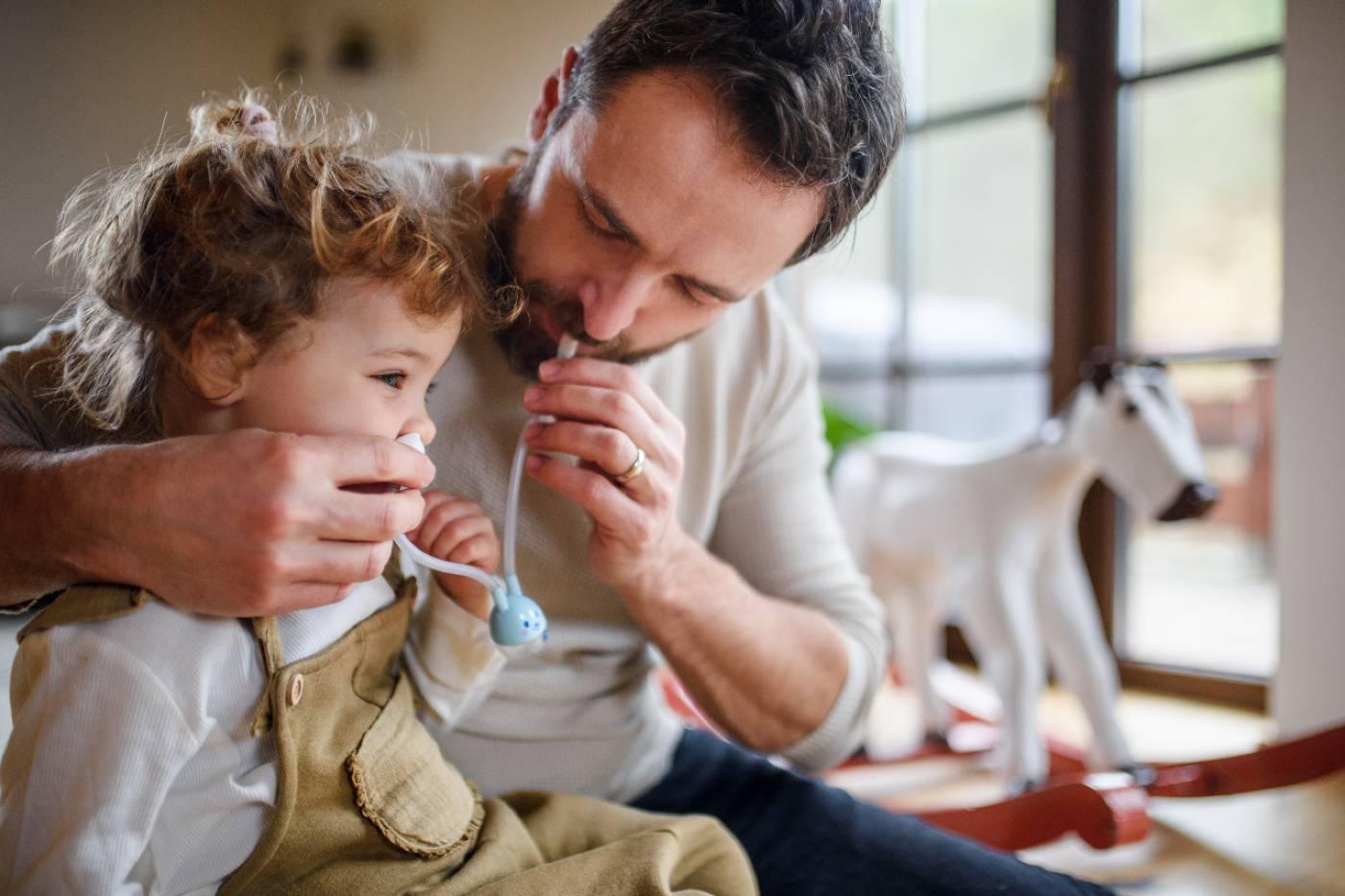 How to suction your child's nose: dad suctioning child's nose