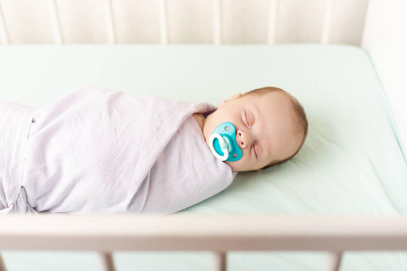 Baby safely sleeping without crib bumper