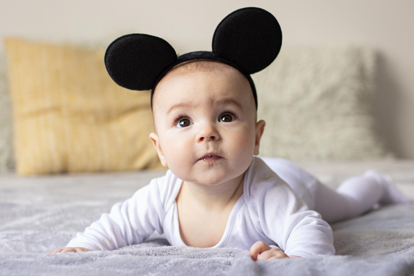 Baby wearing mouse ears