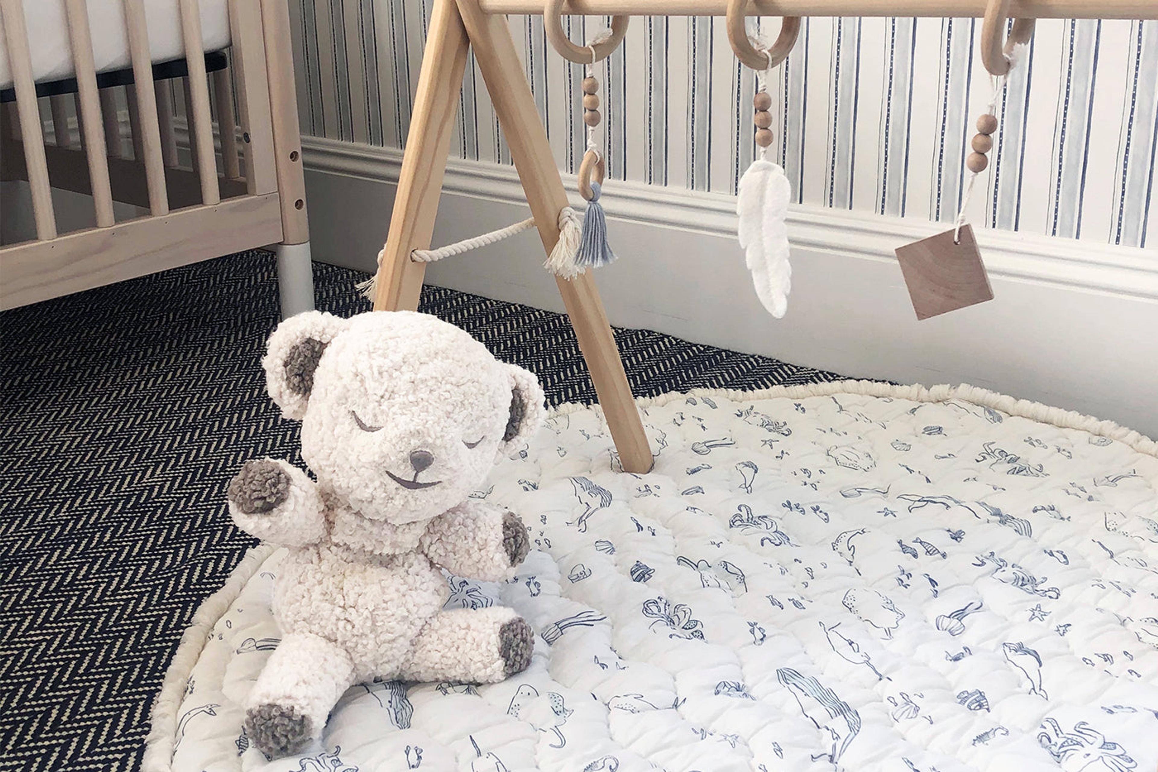 nursery essentials - snoobear white noise machine on a play mat