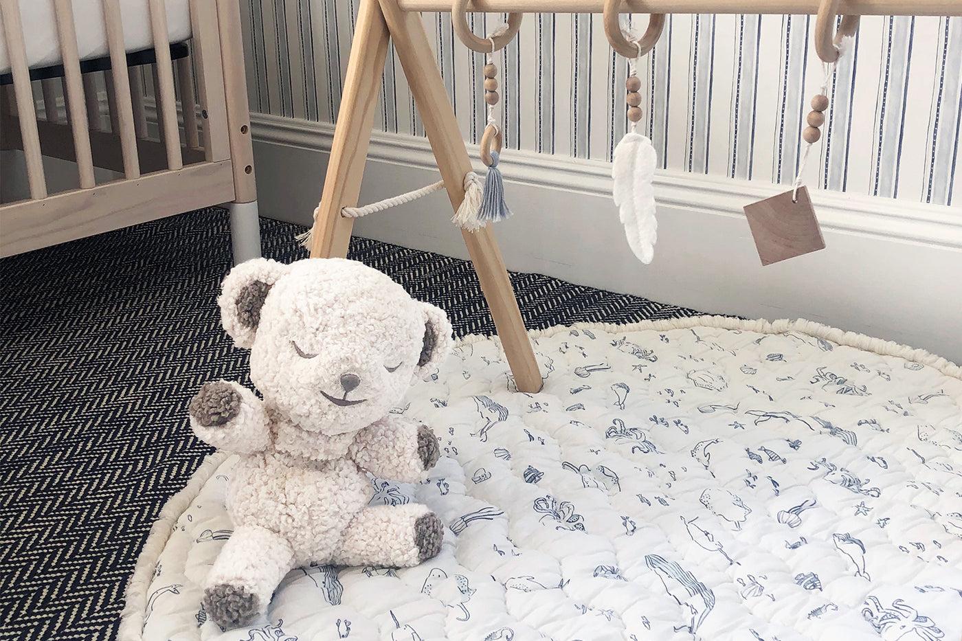 nursery essentials - snoobear white noise machine on a play mat