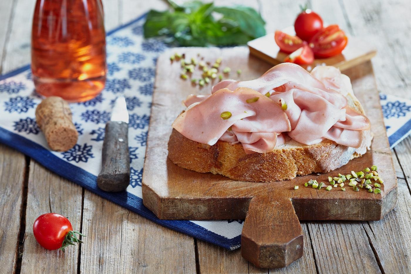 Mortadella ham on bread on a charcuterie board