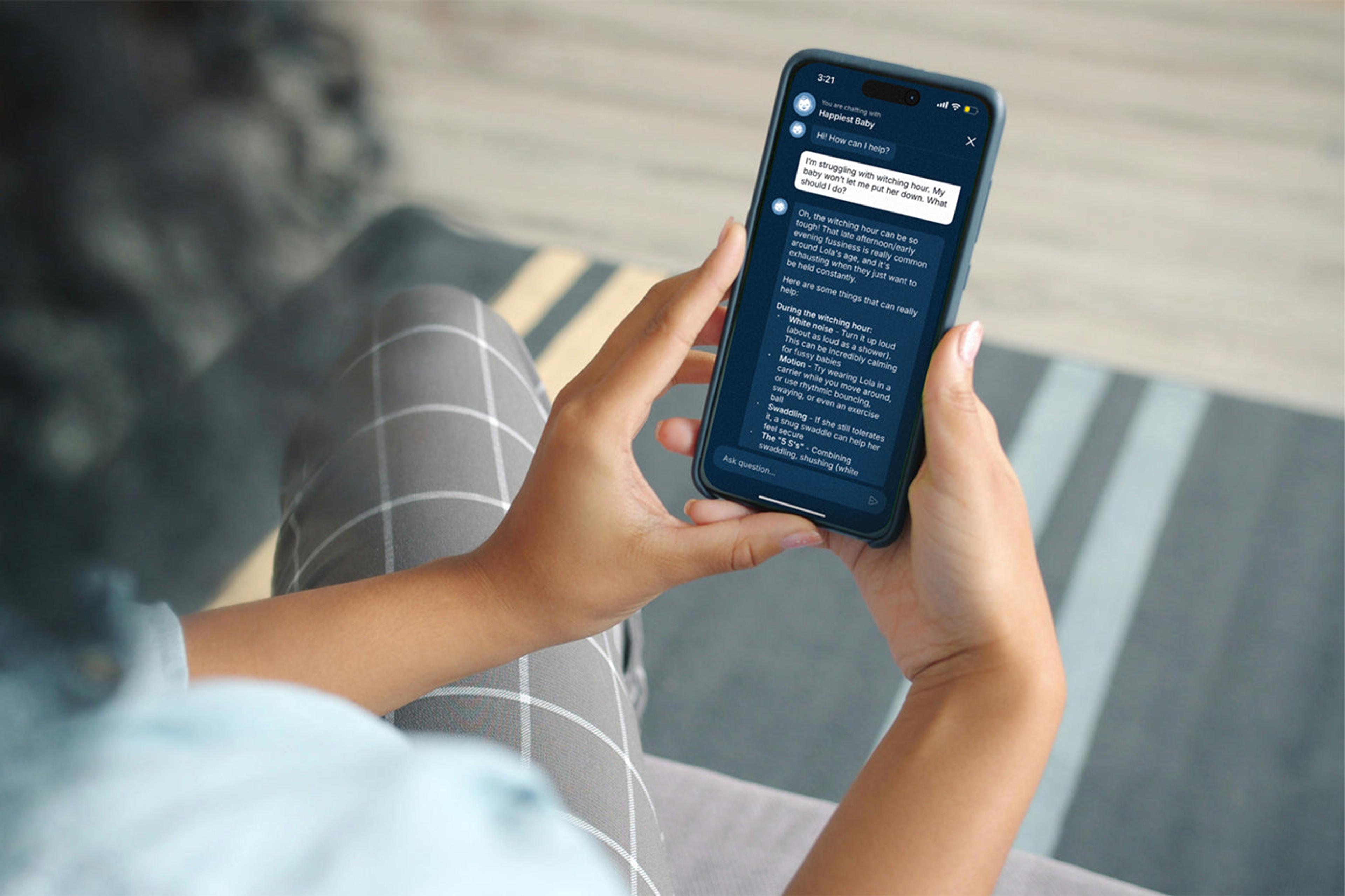 A mom looks at the new chatbot feature on the Happiest Baby App