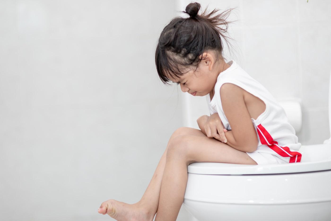 Toddler sitting on toilet refusing to poop
