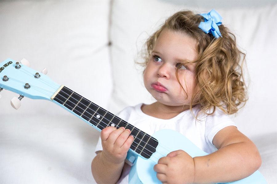 Toddler with a toy guitar