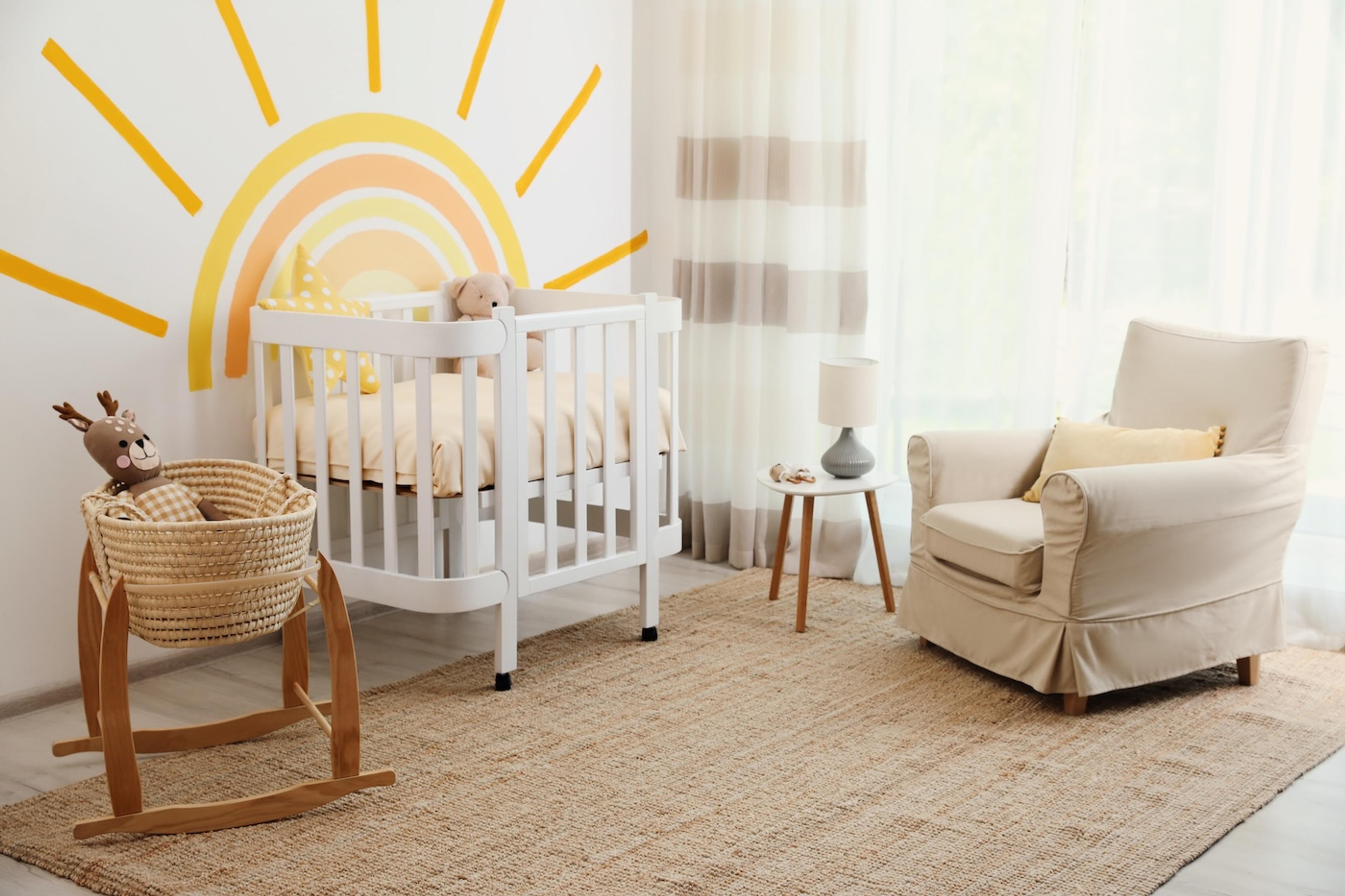 Child's nursery with a sun wall decal behind the crib