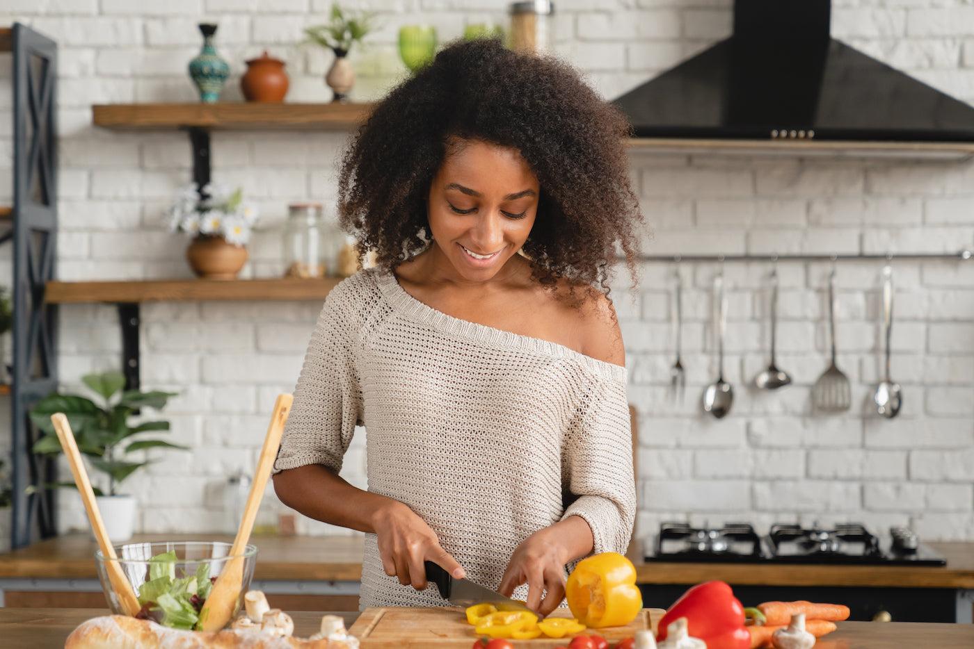 A woman prepares foods to eat as part of a fertility diet