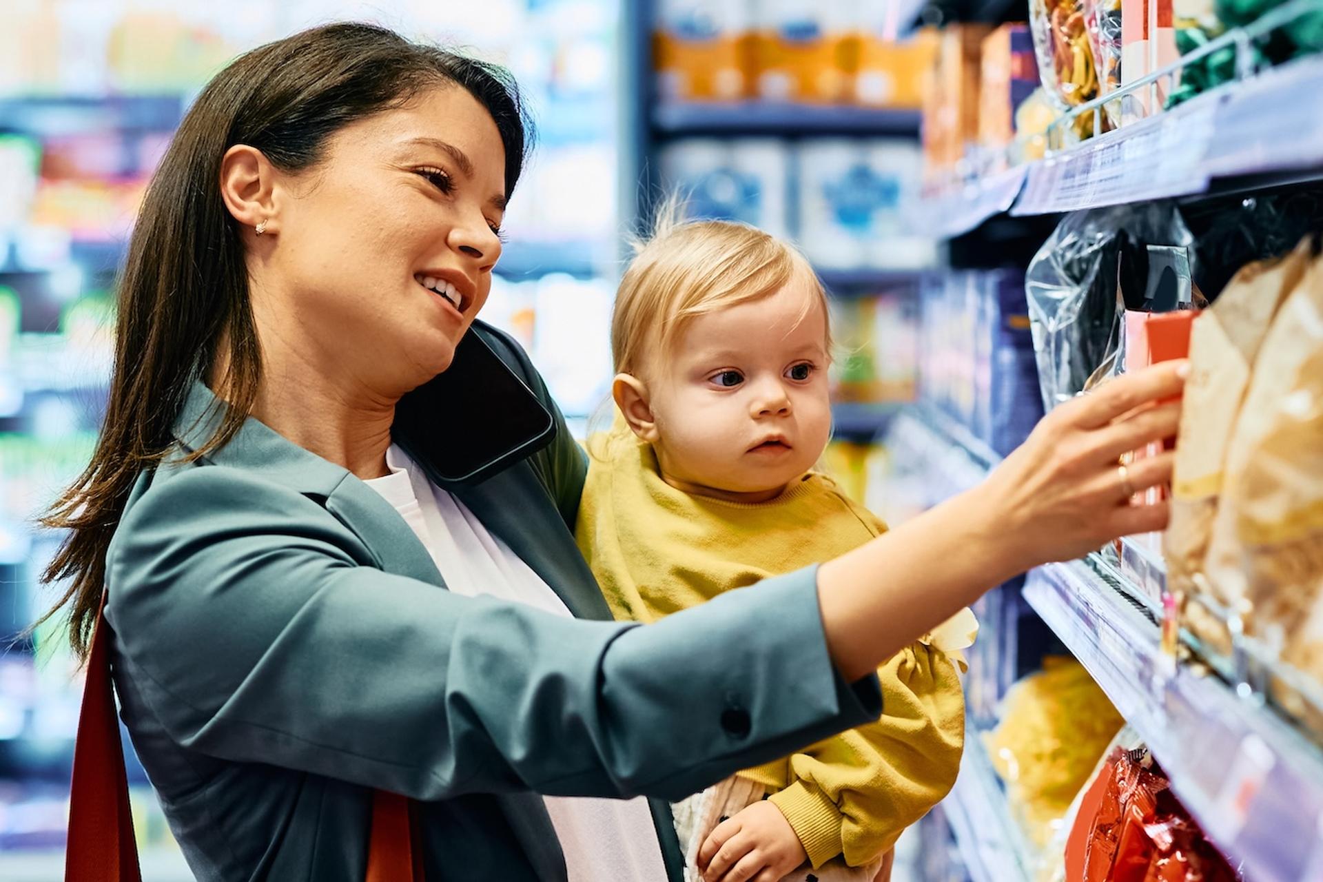 A mom shops for baby foods with her child