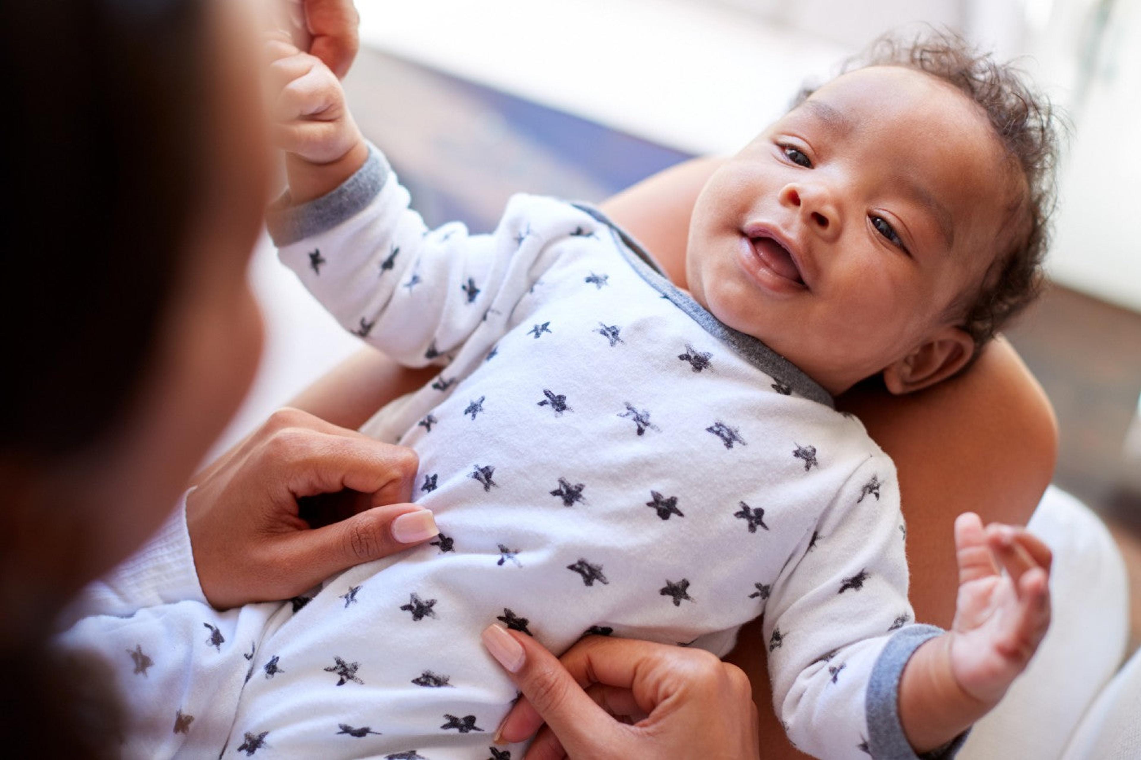 A mom plays with an 11-week-old-baby