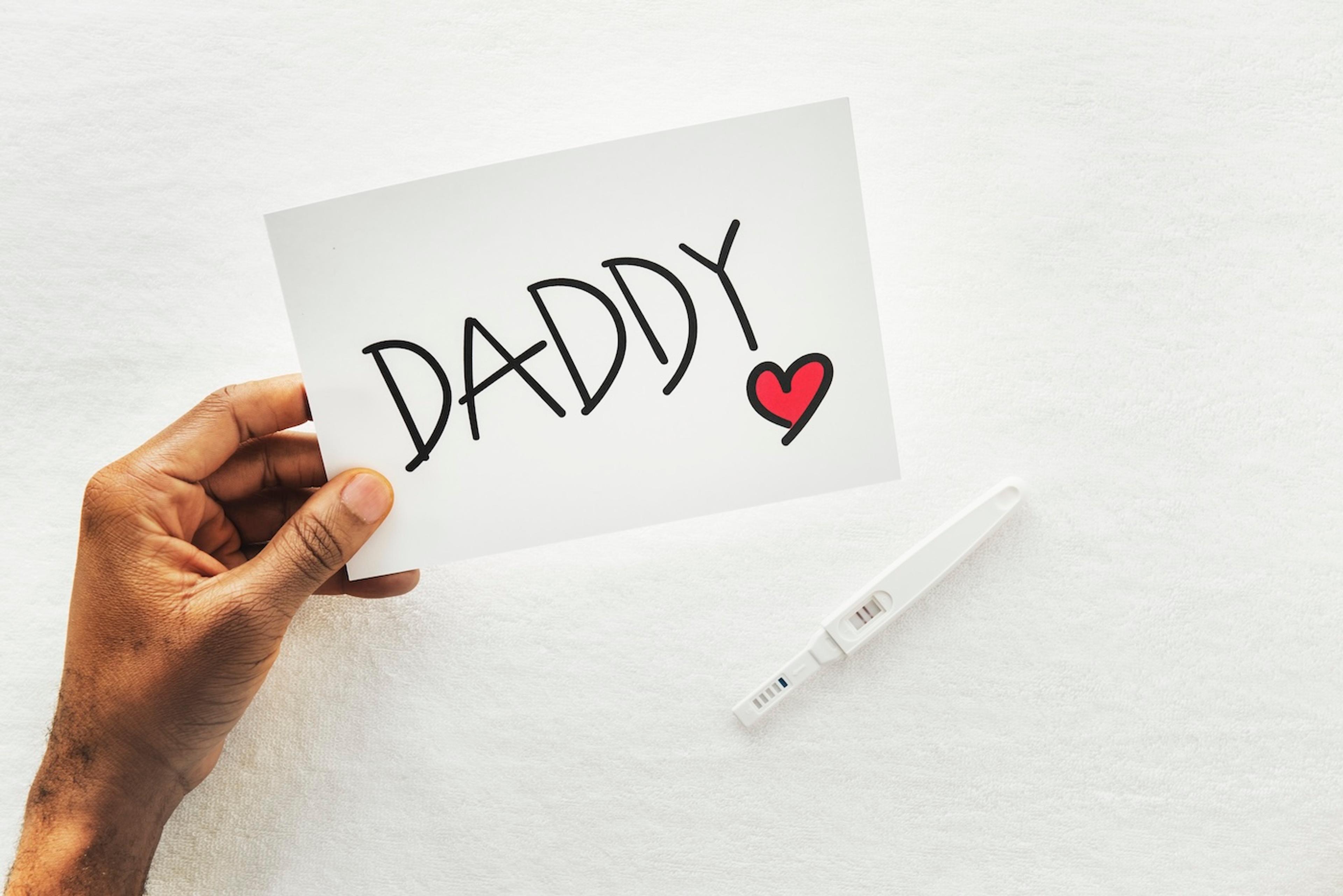 Father's Day pregnancy announcement with a positive pregnancy test