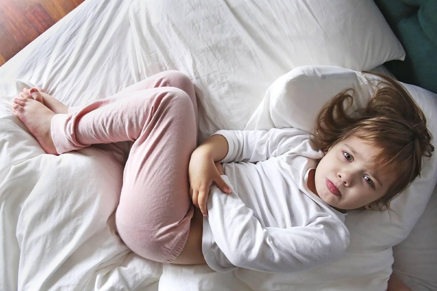 Child in bed with a tummyache