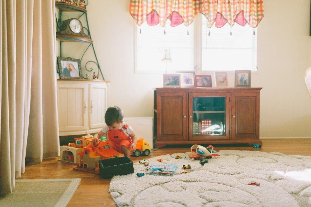 3-year-old playing with toys on the floor