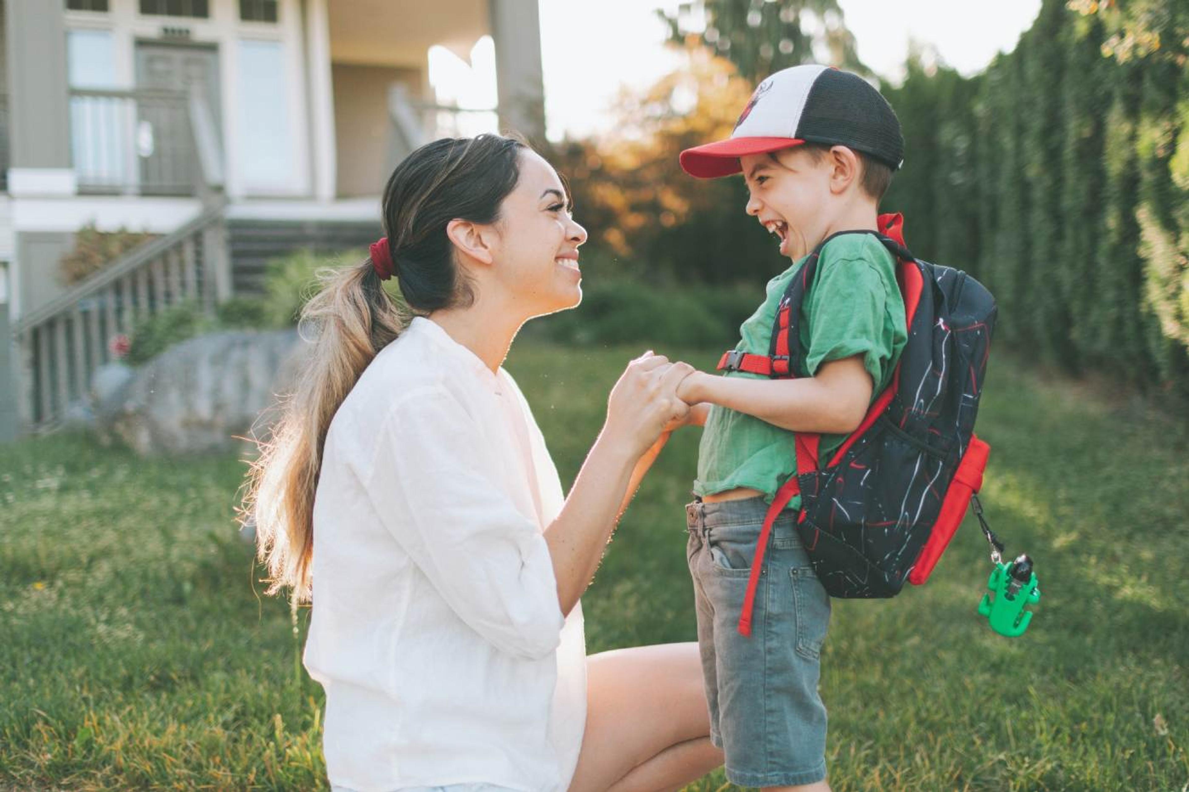 How to prepare for preschool/kindergarten - mother staring lovingly at son who is ready for his first day of school