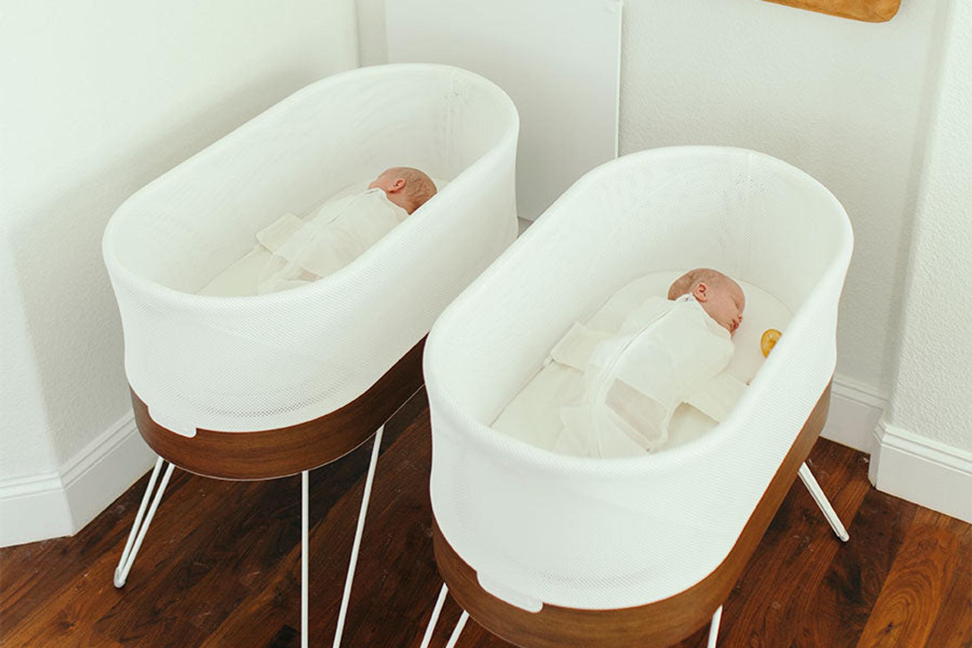 Twin babies sleeping in two SNOOs