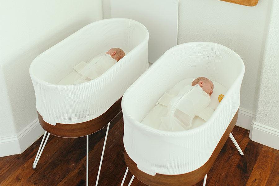 Twin babies sleeping in two SNOOs
