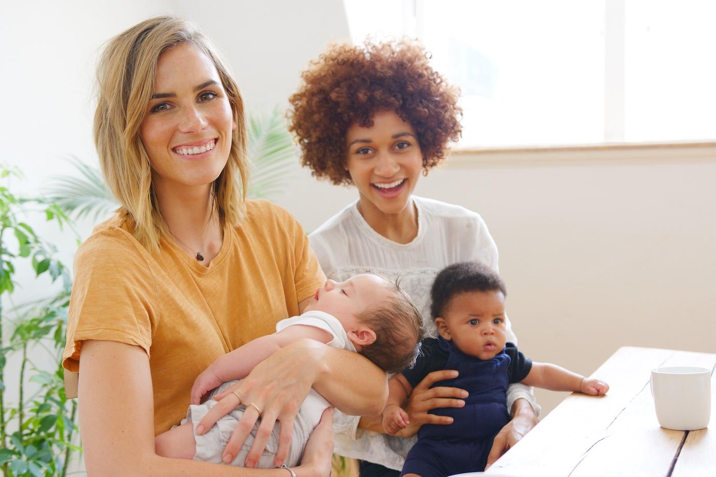 Two moms in community with their babies