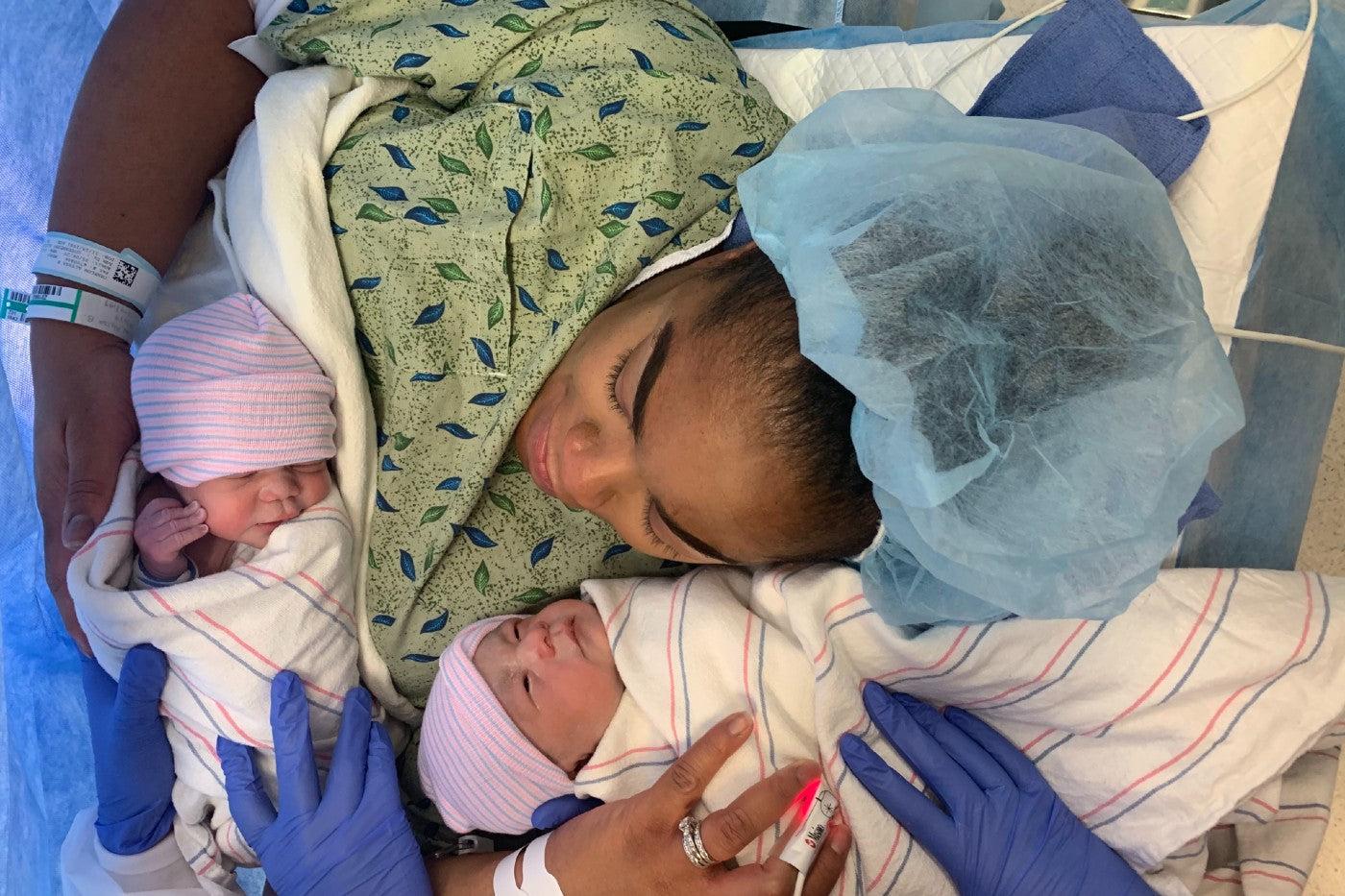 New mom Alyssa cradles her newborn twins immediately after giving birth