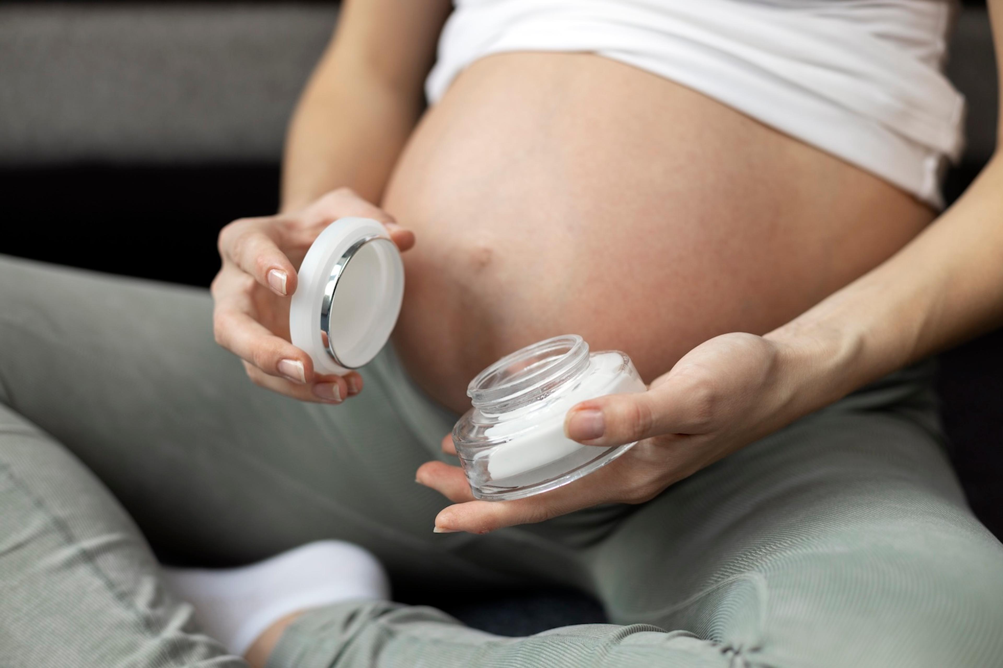 A pregnant woman contemplates using a retinol cream