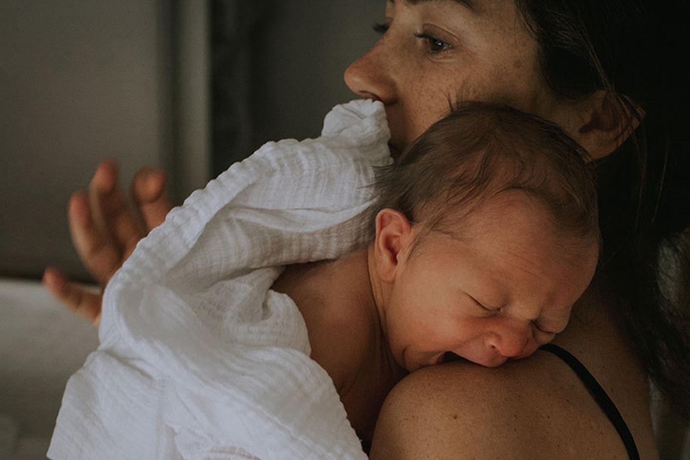 Mother holds baby during the 3- to 4-month sleep regression