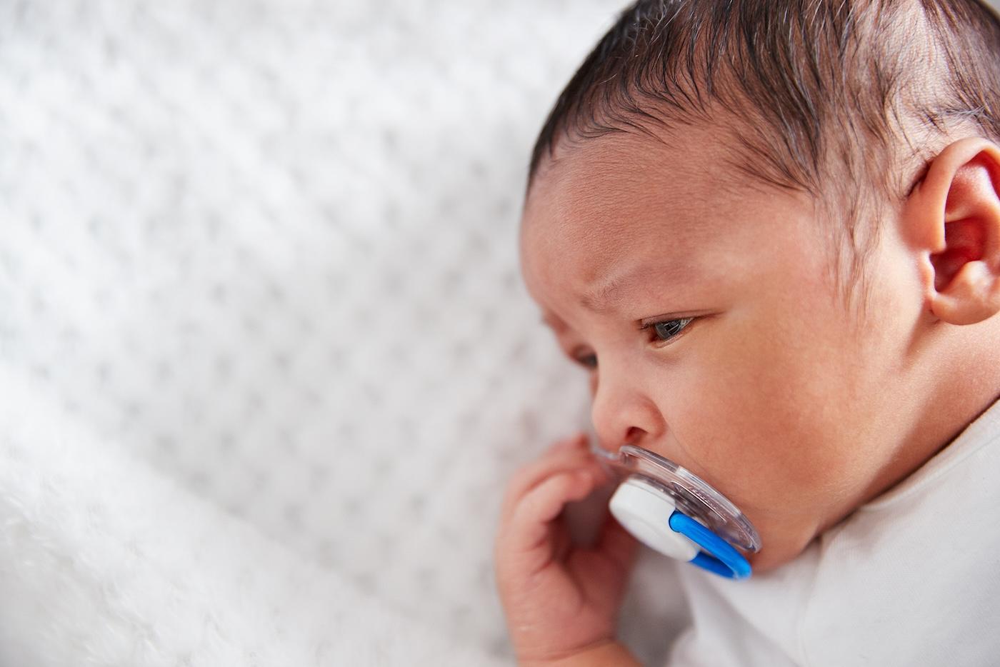 Baby sucking on pacifier