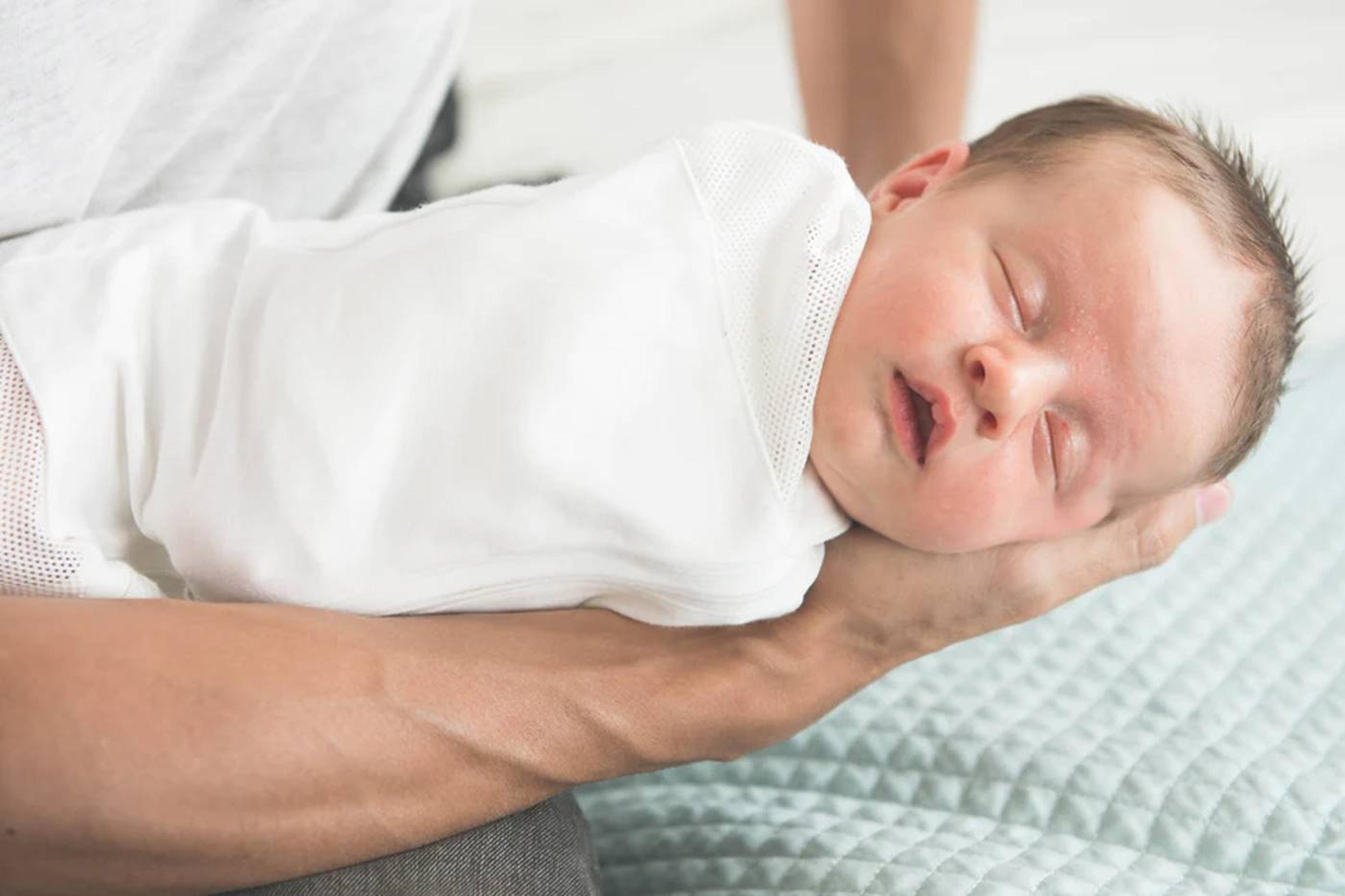 Swaddled sleeping baby benefiting from the 5 S's