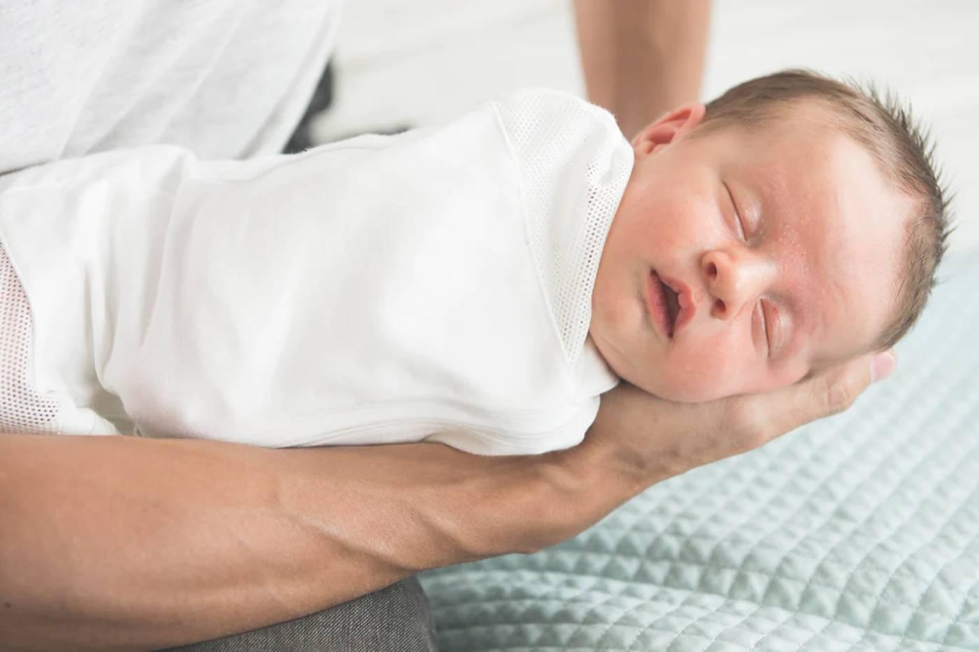 Swaddled sleeping baby benefiting from the 5 S's