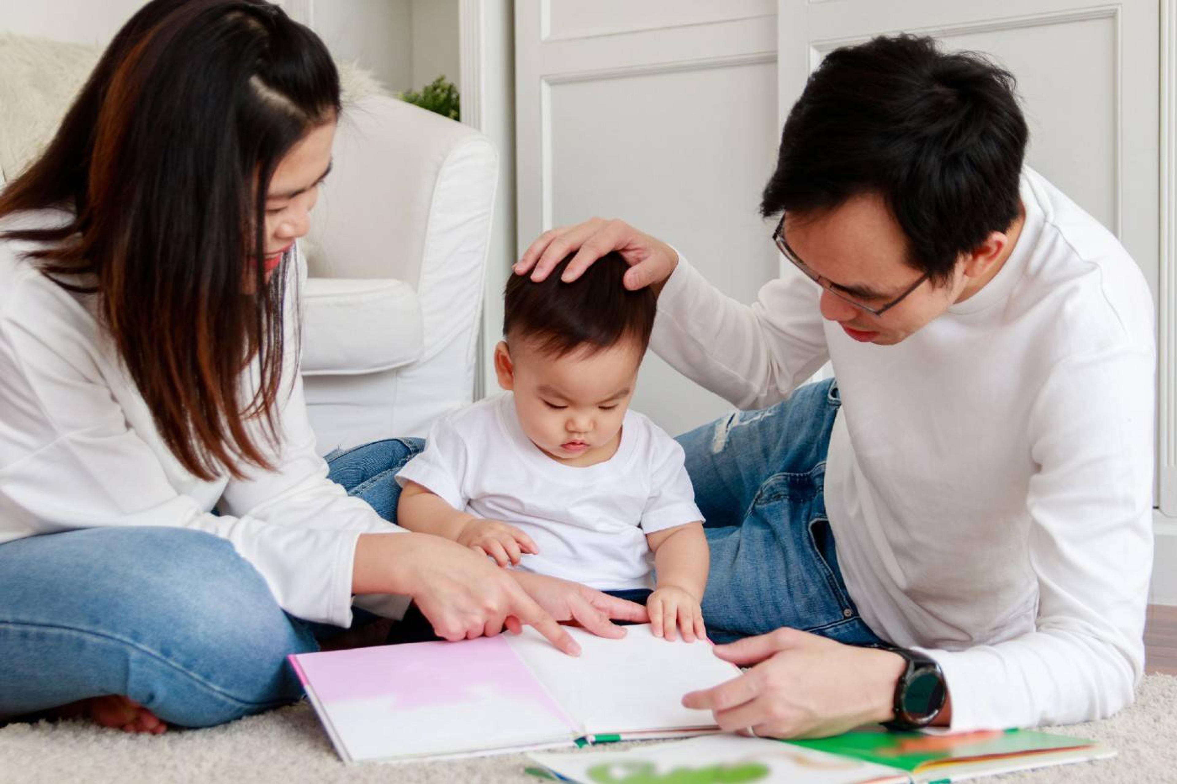 Family reading color books with toddler