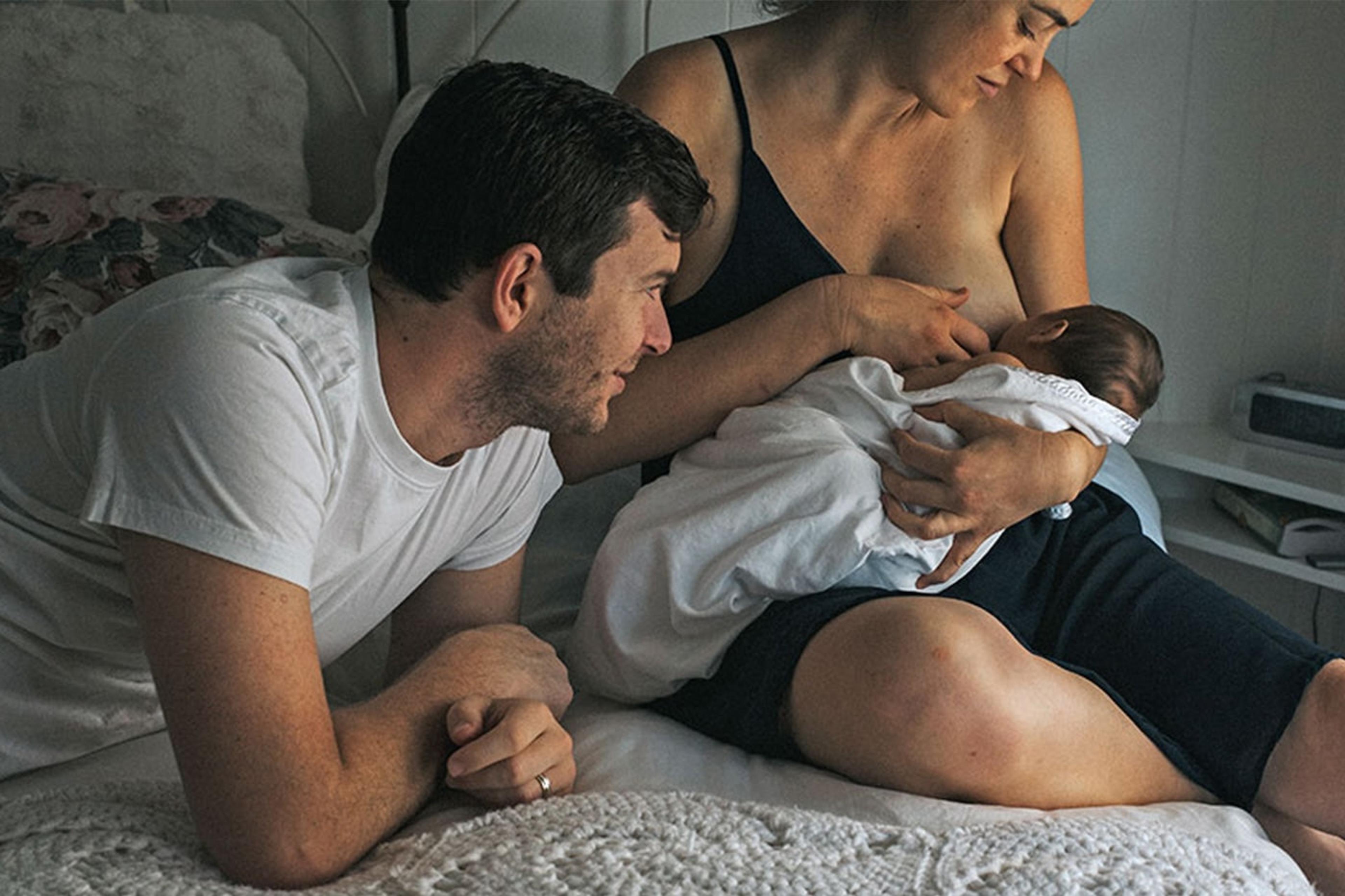 A mother dream feeds her newborn baby