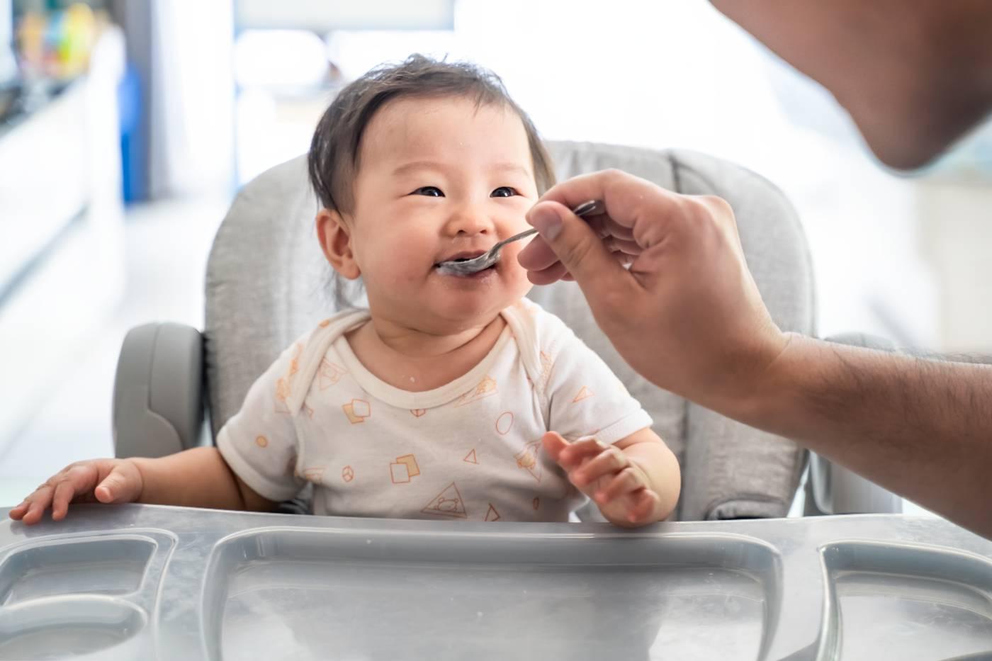 Lead in baby food; father feeding baby