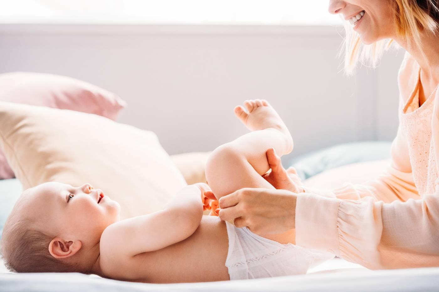 woman changing baby's diaper
