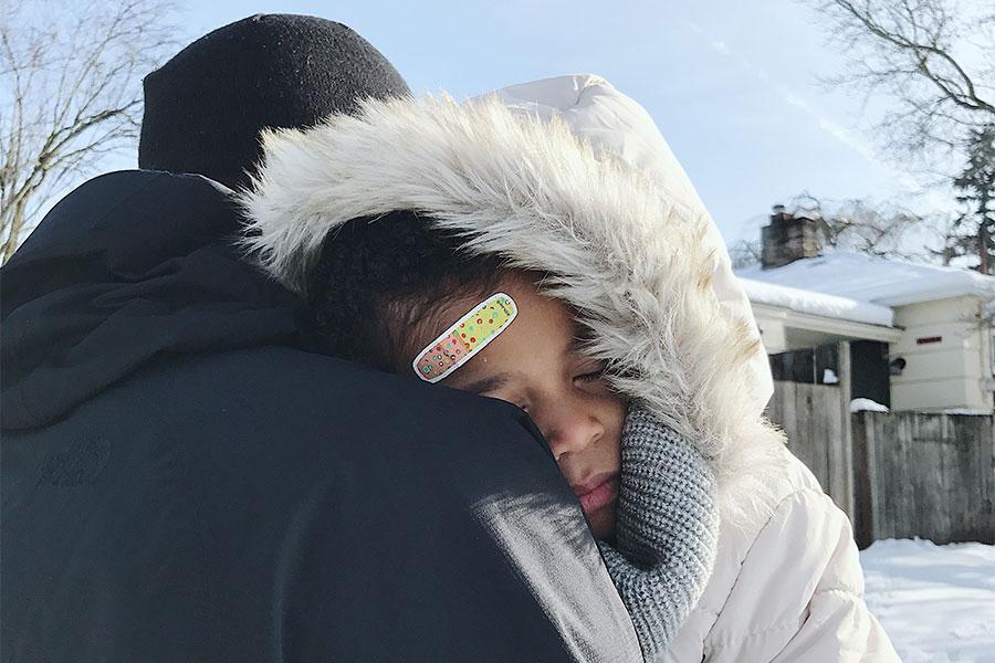 Toddler sleeping on parent's shoulder