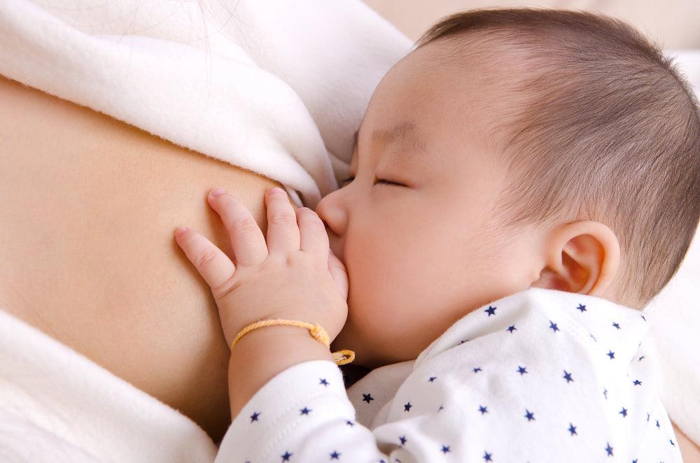 baby breastfeeding from mom with low milk supply
