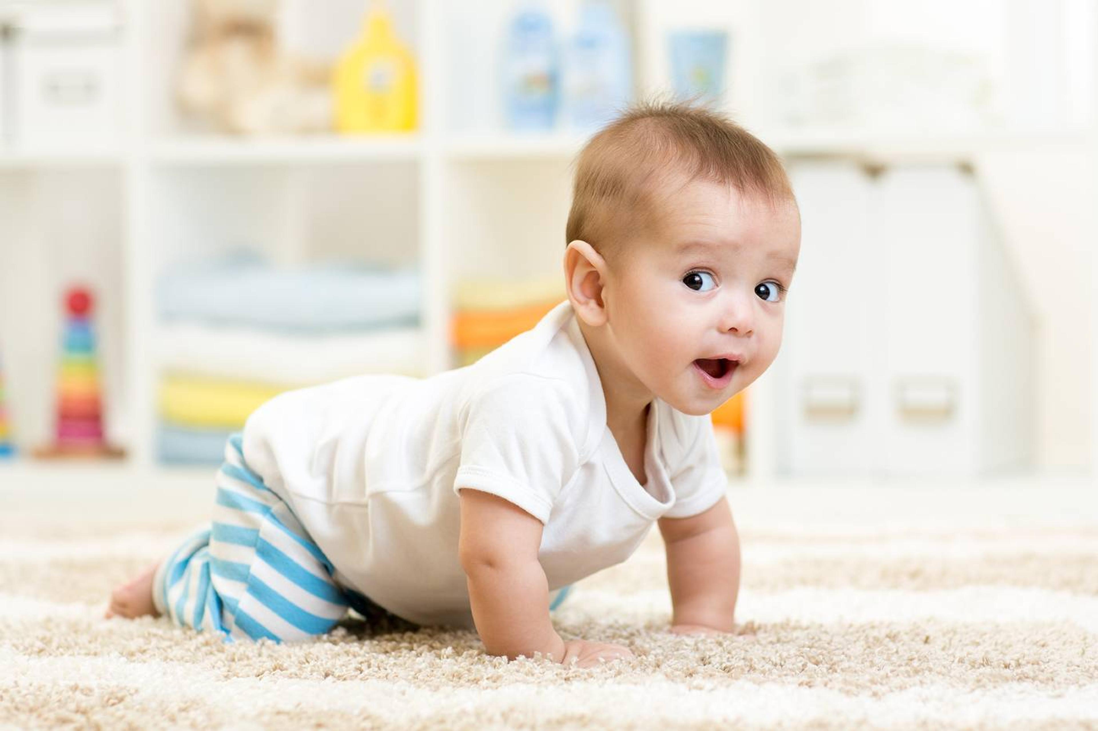 Cute baby crawling on rug