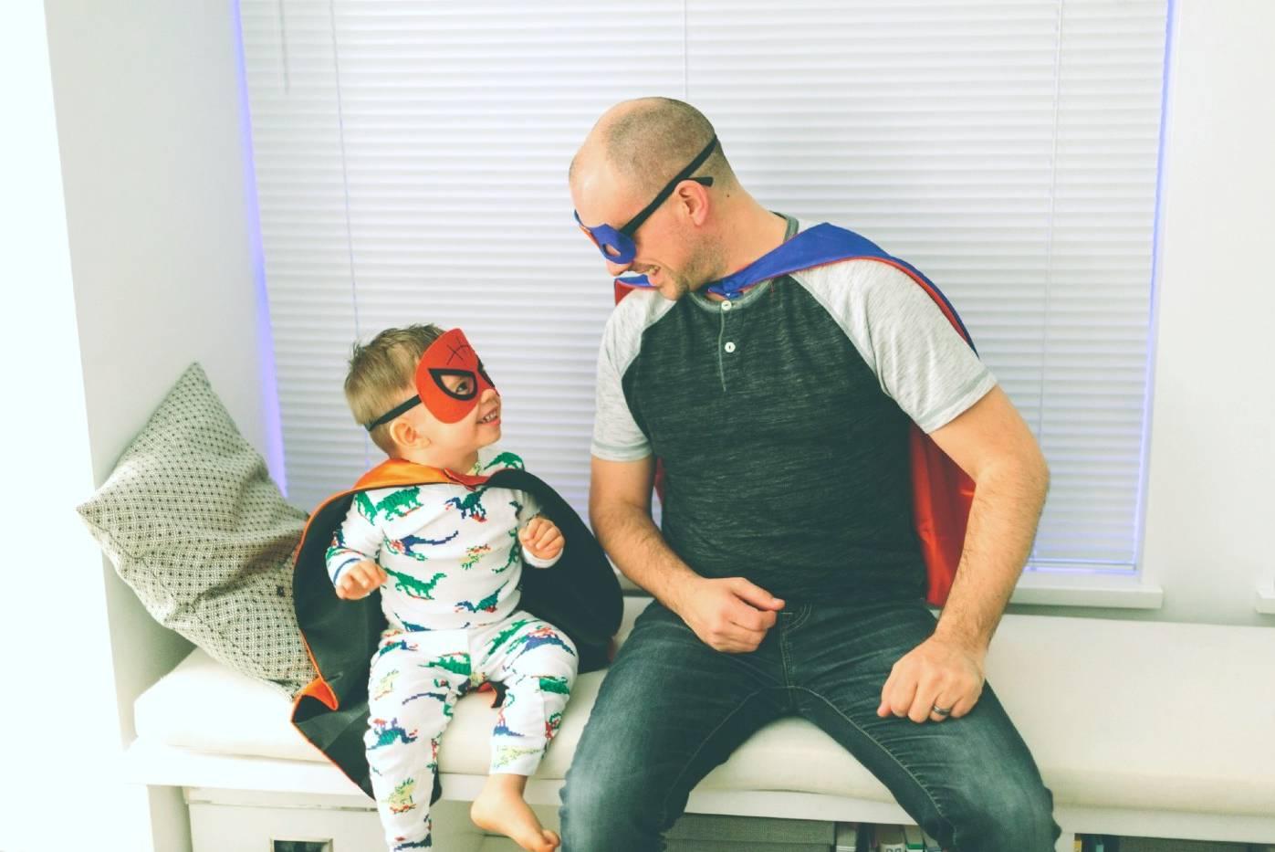 Toddler and dad dressed as superheros