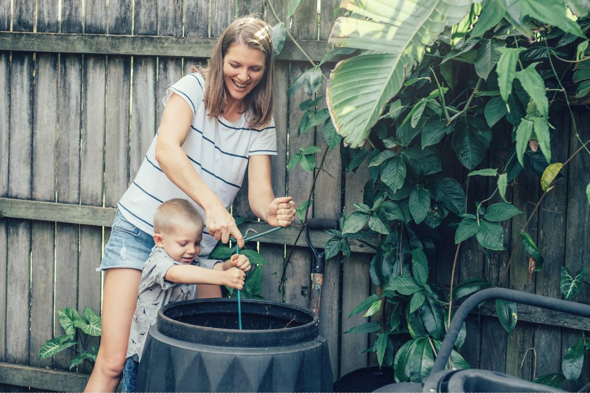 Mom and child composting outdoors
