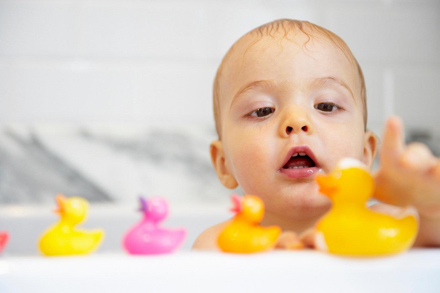 A baby and clean rubber duck bath toys
