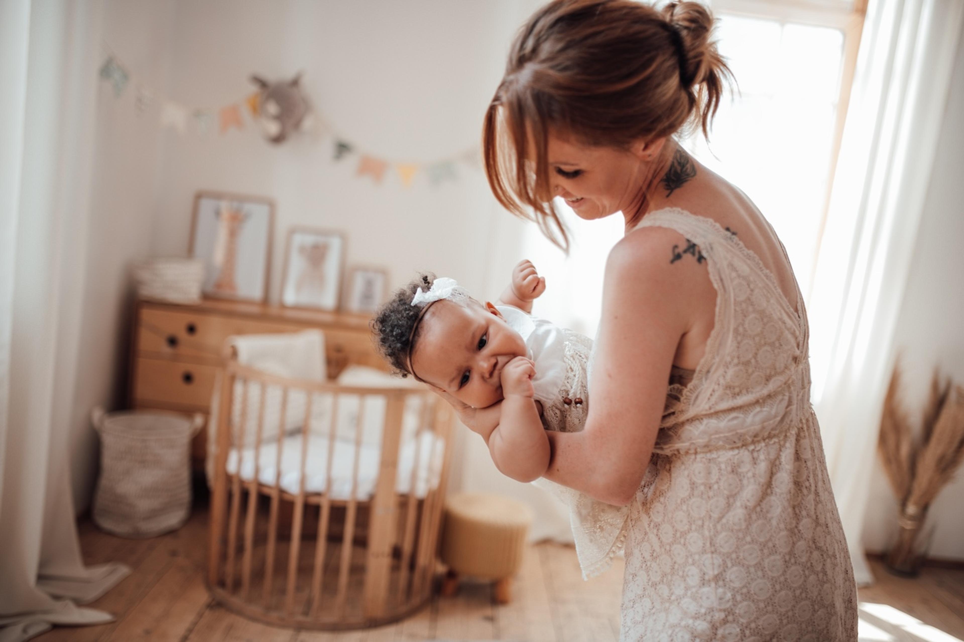 A mother sings a lullaby to her baby