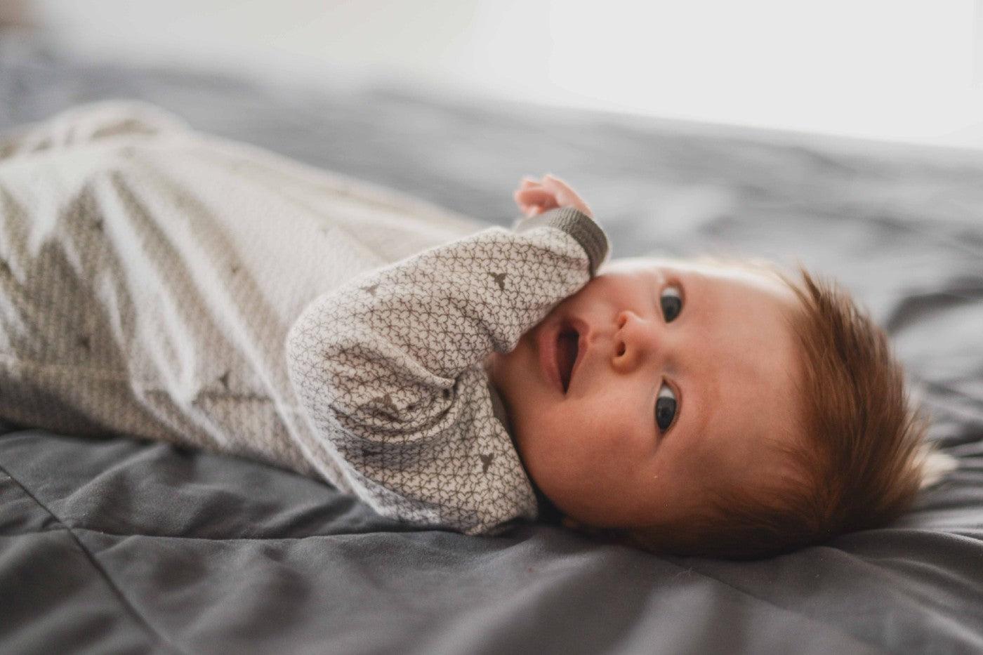 10-week-old baby boy lies on his back