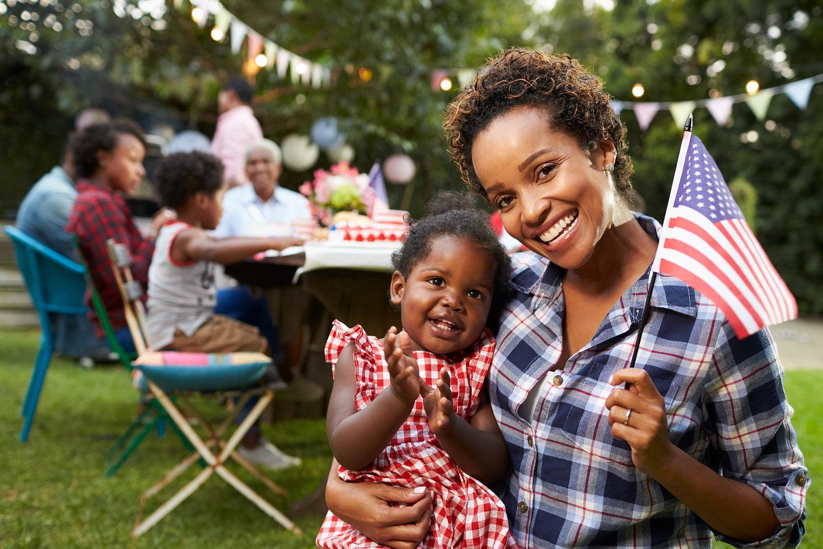 mom and child holding American flag on 4th of July