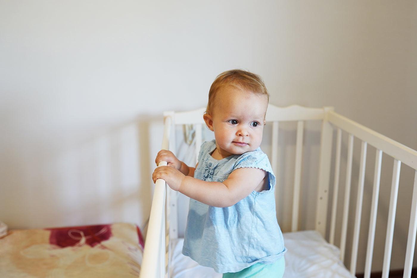 9 month sleep regression: baby pulling up to stand in crib