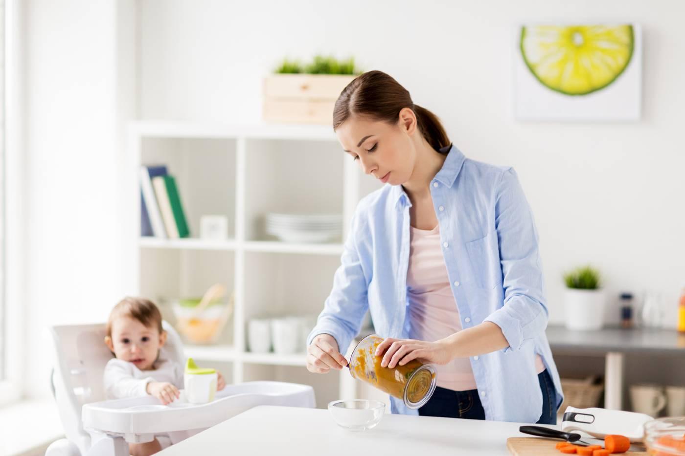 Mom making homemade baby food for her baby