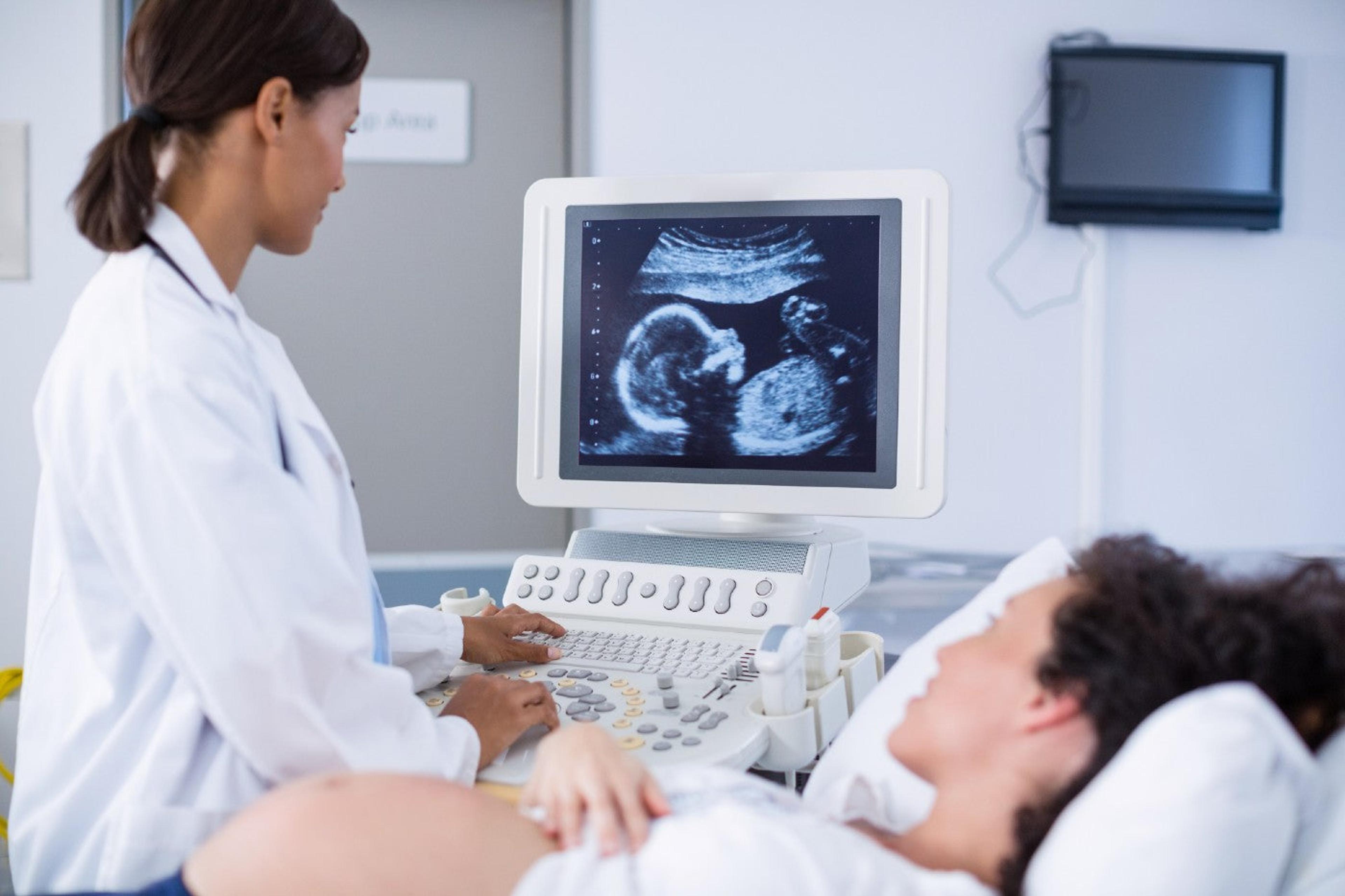 A doctor gives a pregnant woman a prenatal ultrasound