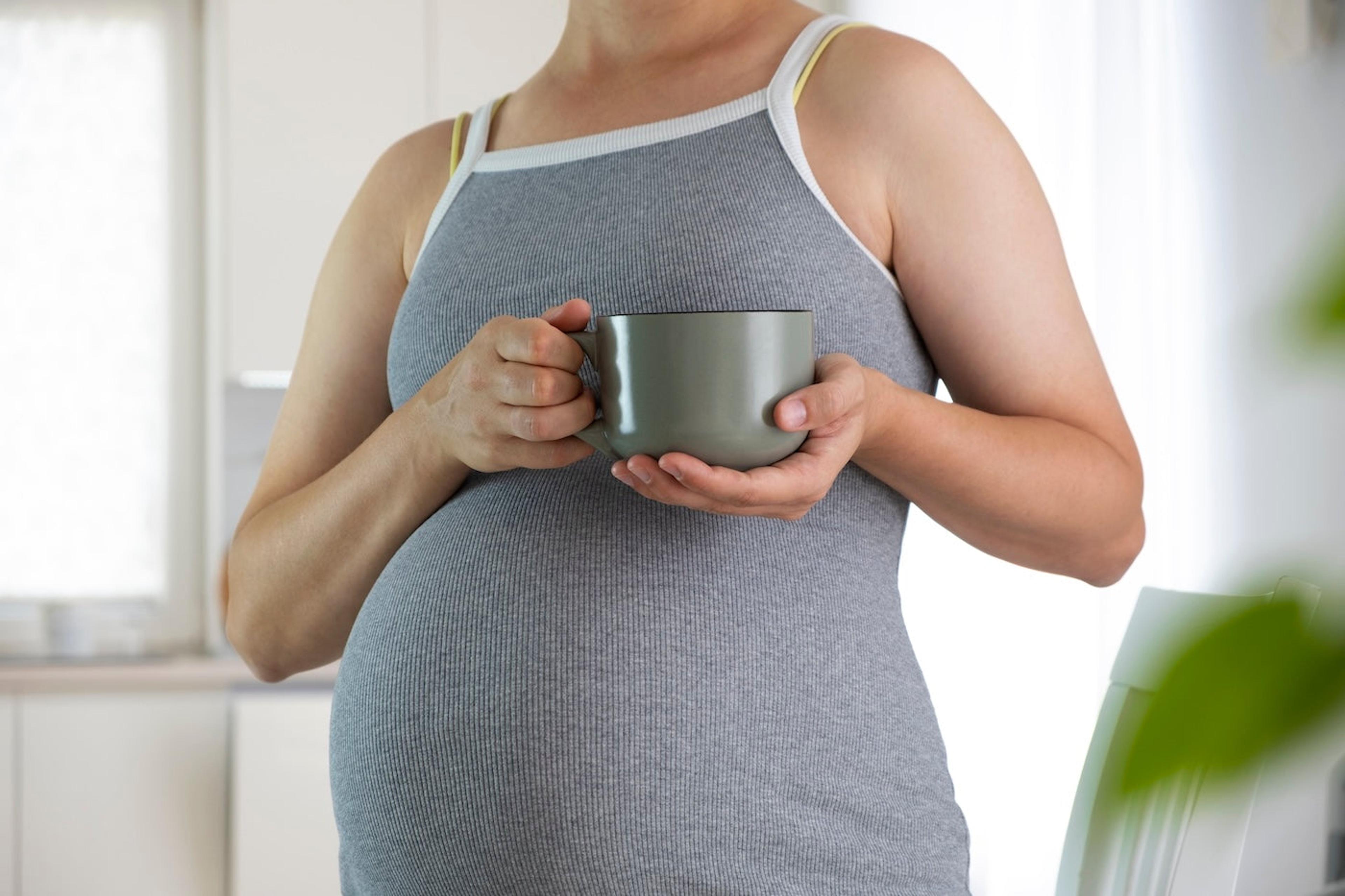 Pregnant woman holding a mug of tea