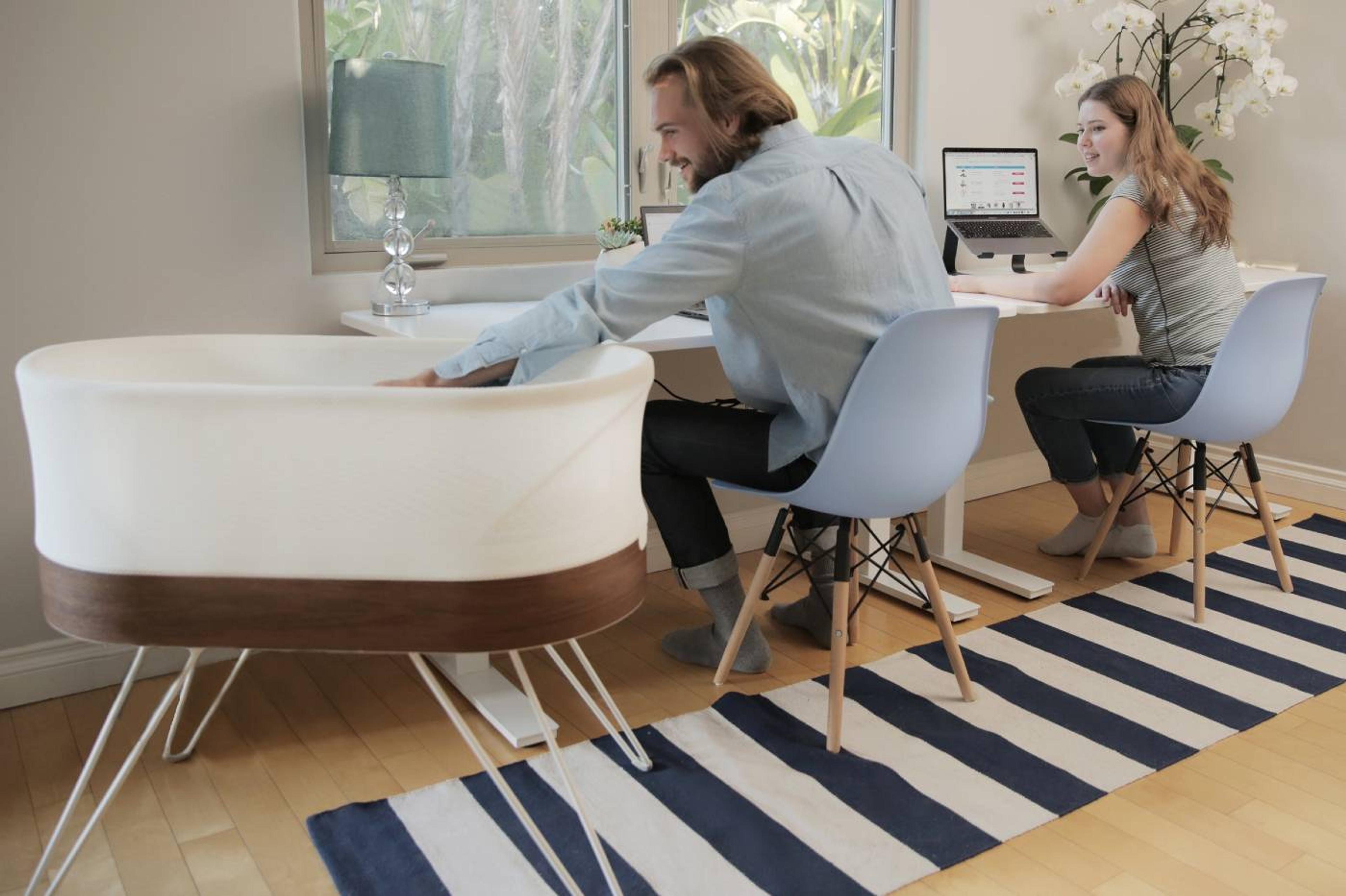 Couple working from home with SNOO from corporate rental