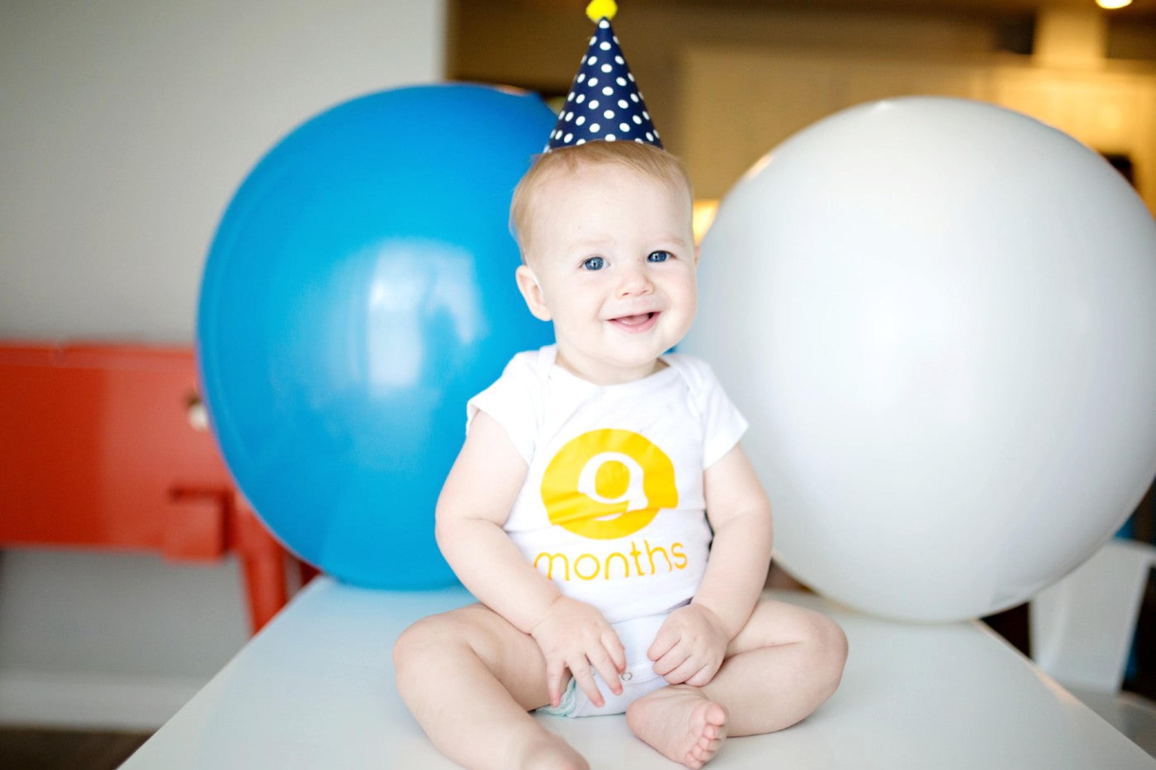9-month-old baby wearing a party hat