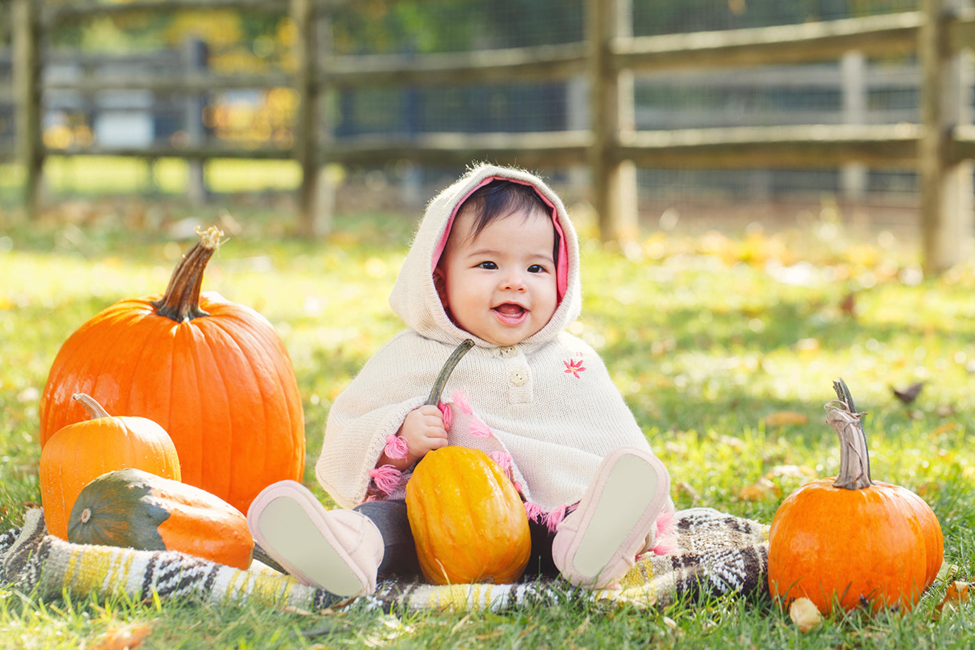 baby with pumpkins